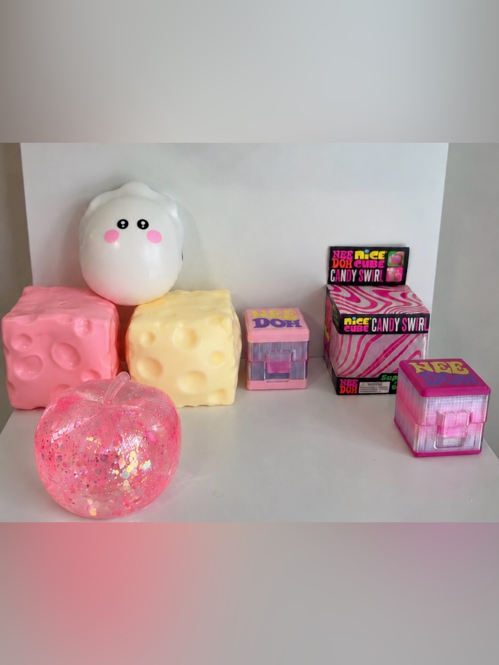 NeeDoh candy swirl, 2 NeeDoh cases, Mellowswjish crunchy cheese, moldable pink